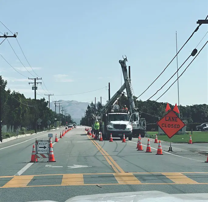 A crane is being used to repair power lines.