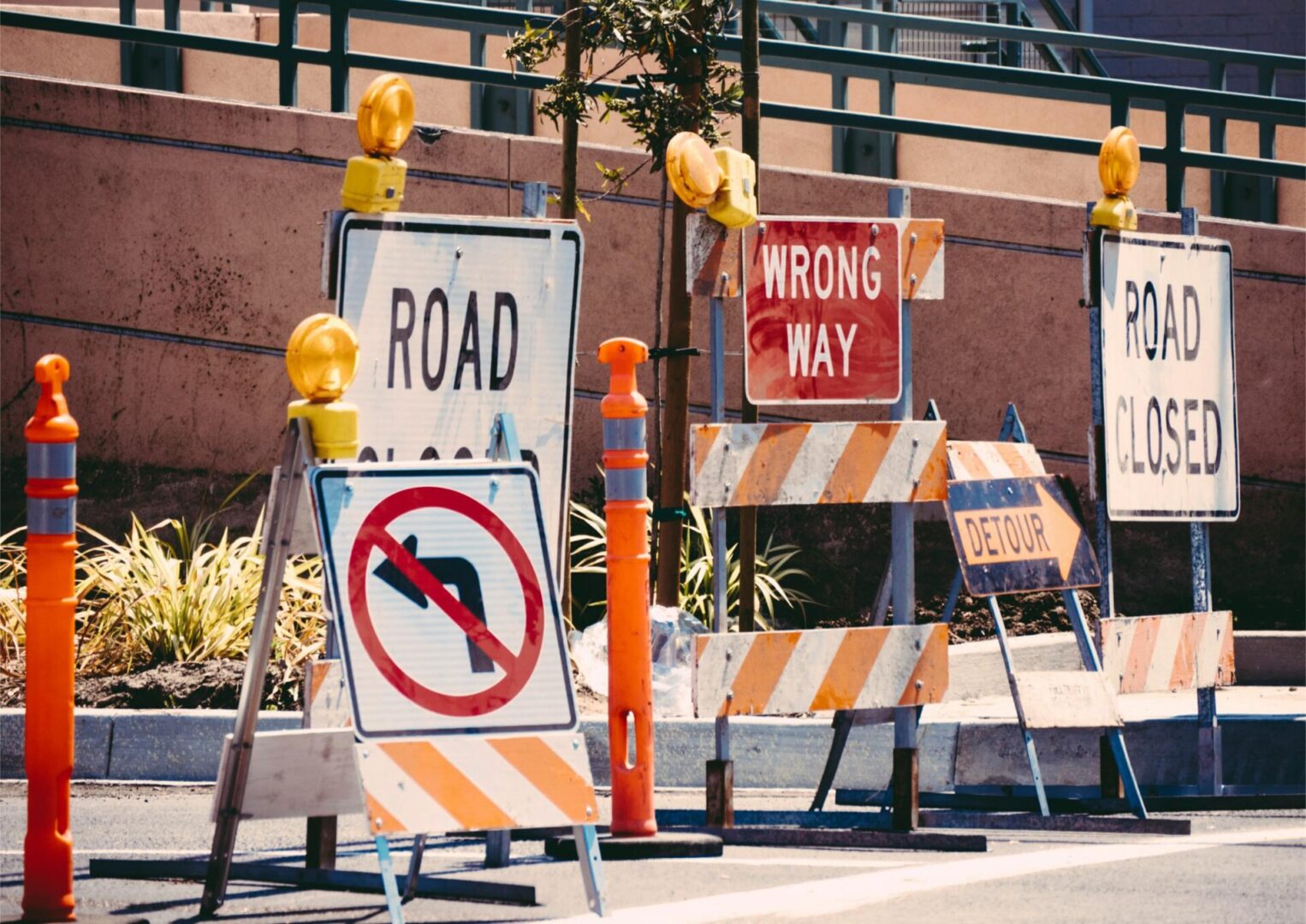 A bunch of construction signs are on the side of the road.