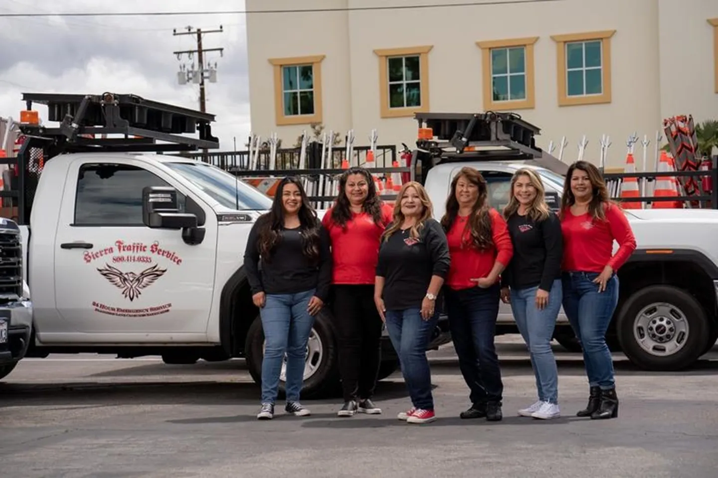 A group of women standing in front of a truck.